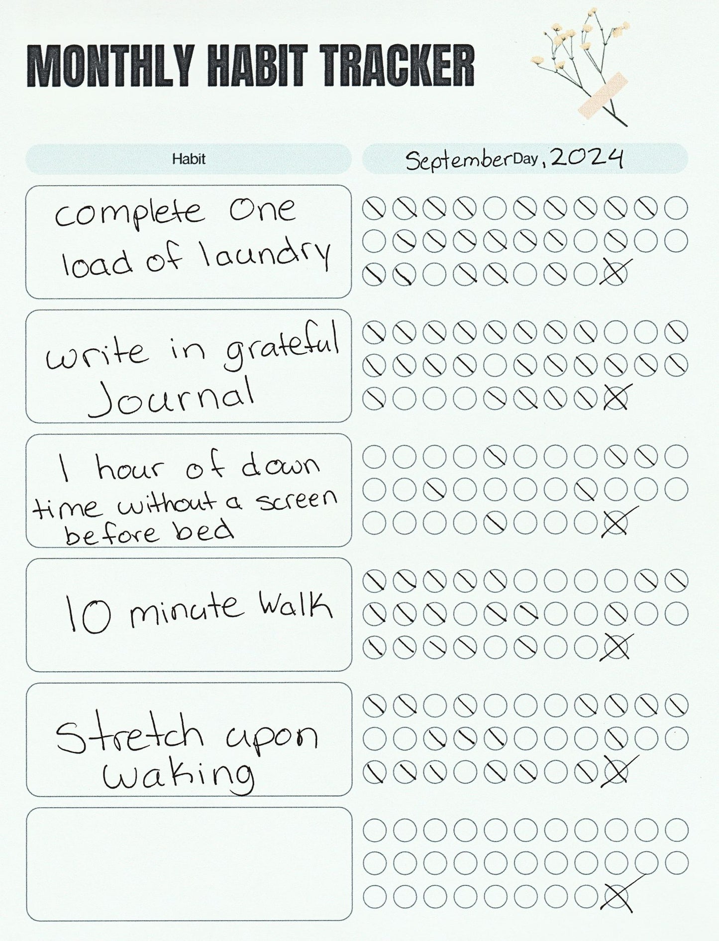 Monthly habit tracker with checkboxes and a flower decoration.